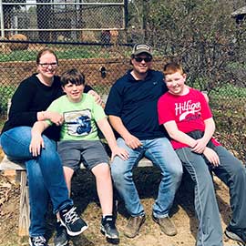 Family photo of Mandy with her husband and sons